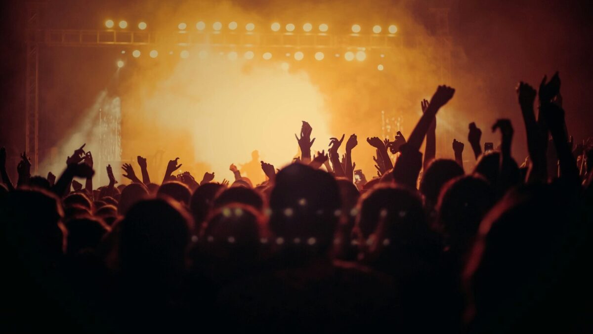 band performing on stage in front of people